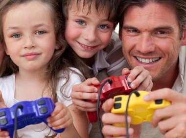 Happy father and his children playing video games clipart