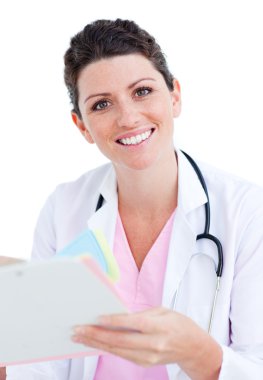 Brunette doctor reading paper and holding a stethoscope clipart