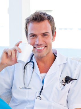 Smiling doctor having a break clipart