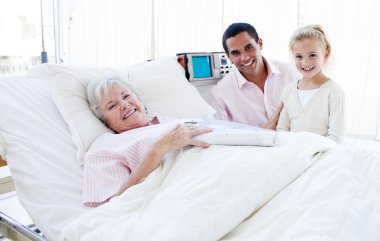 Smiling little girl with her father visiting her grandmother clipart