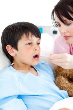 Young nurse taking her patient's temperature clipart