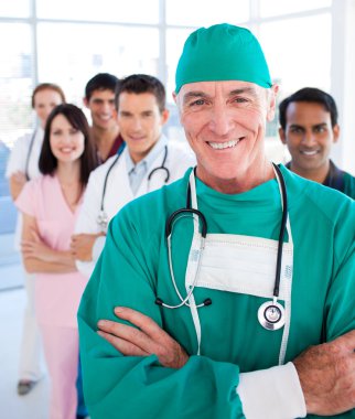 Multi-ethnic medical group smiling at the camera clipart