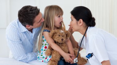 Doctor examining child's throat clipart