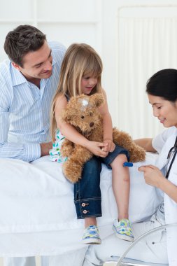 A doctor checking child's clipart