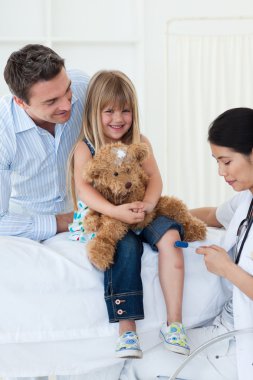 Female doctor checking patient's reflex clipart