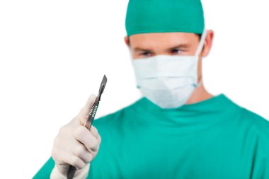 Self-assured surgeon holding a scalpel clipart