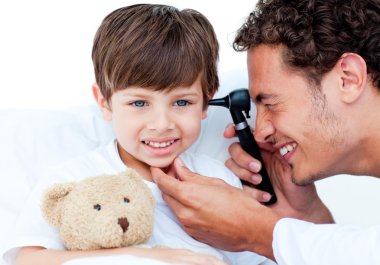 Attractive doctor examining patient's ears clipart