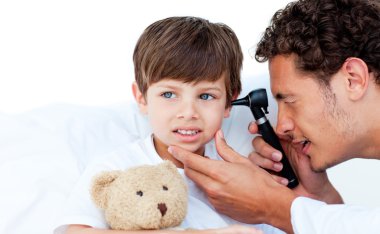 Concentrated doctor examining patient's ears clipart