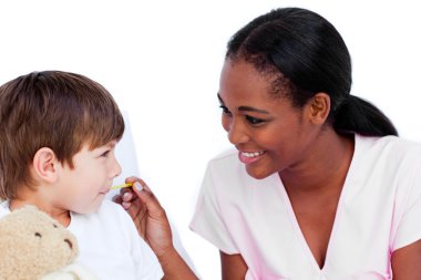 Smiling doctor taking child's temperature clipart