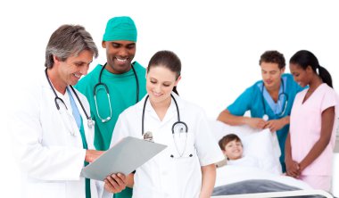 Smiling medical team in a patient's bedroom clipart