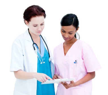 Assertive female doctor and nurse studying a patient's folder clipart