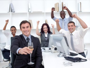 Successful businessteam driking champagne in office clipart