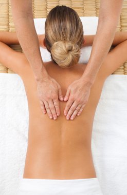 Young woman having a massage clipart