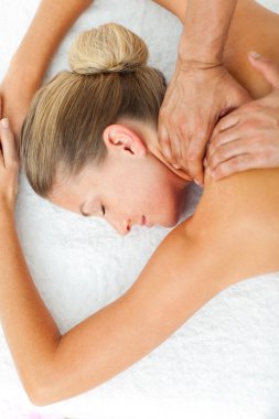 Asleep woman enjoying a massage clipart