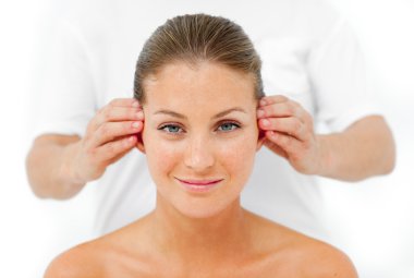 Charismatic woman having a head massage clipart