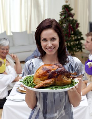 Woman showing to the camera Christmas turkey clipart