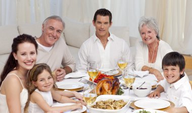 Family having a dinner together at home clipart