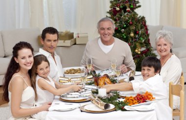 Children pulling a Christmas cracker at home clipart