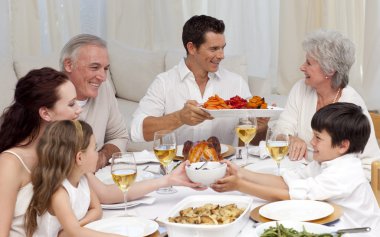 Family having a big dinner at home clipart