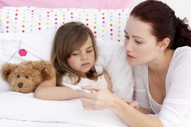 Mother taking sick daughter's temperature clipart