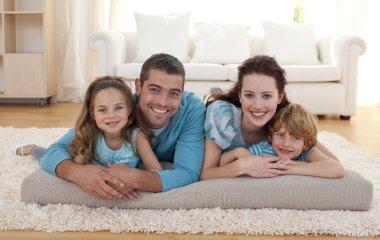 Family on floor in living-room clipart