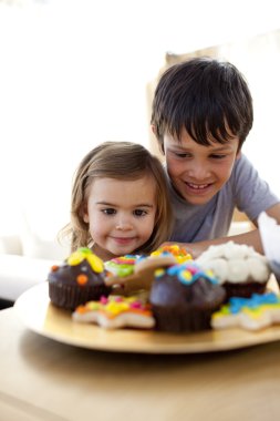 Brother and sister looking at confectionery clipart