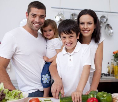 Son preparing food with his family clipart