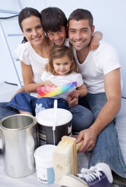 Family chosing colours to paint new house clipart