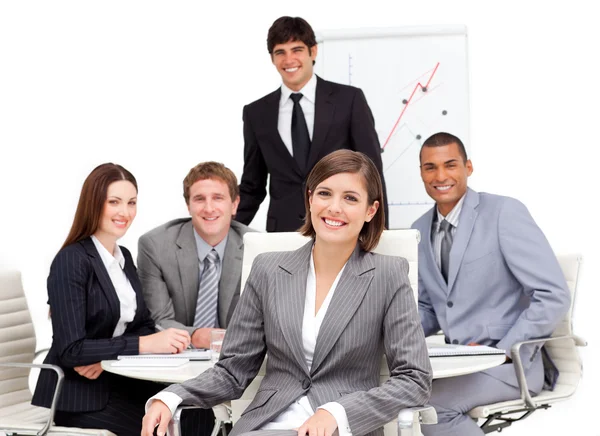 Charming businesswoman sitting in front of her team — Stock Photo, Image