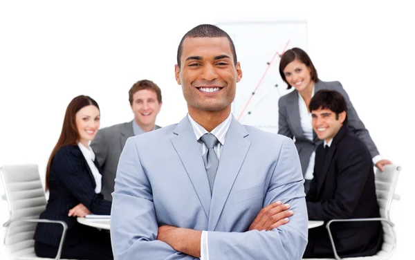 Confident manager with folded arms in front on his team — Stock Photo, Image