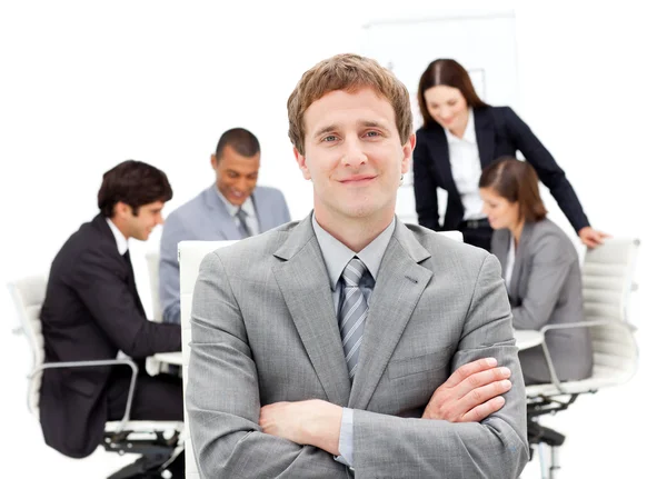 Caucasian businessman sitting in front of his team — Stock Photo, Image