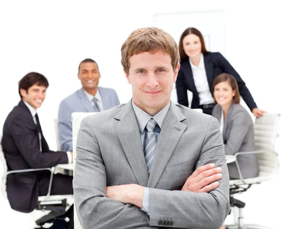Charming manager with folded arms in front on his team — Stock Photo, Image