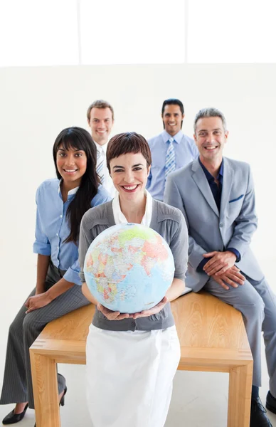 Multi-ethnic business holding a terrestrial globe — Stock Photo, Image