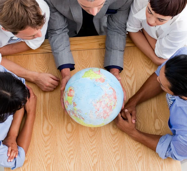 Close-up of business looking at a globe — Stock Photo, Image