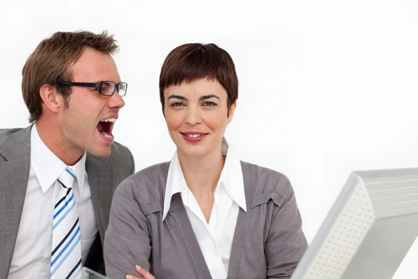 Young businessman shouting into his colleague's ear — Stock Photo, Image
