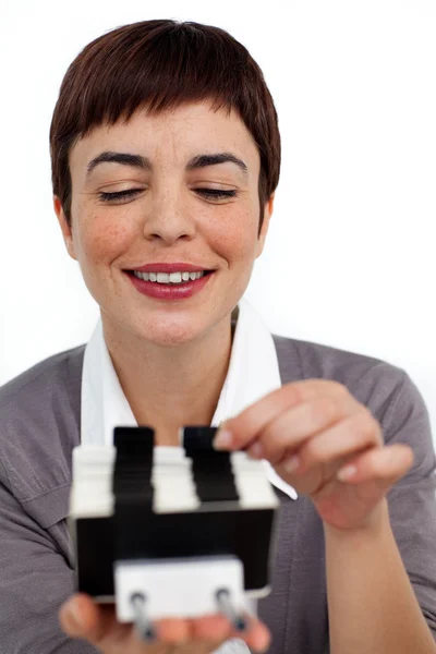Confident businesswoman consulting a business card holder — Stock Photo, Image