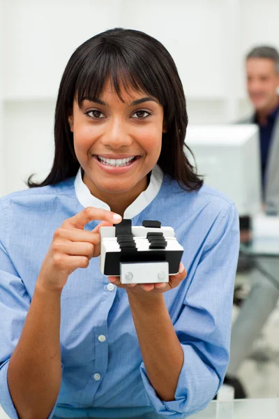 Self-assured businesswoman holding a business card holder — Stock Photo, Image