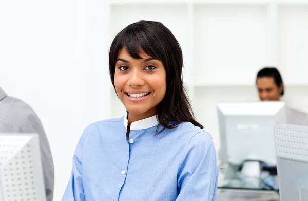 Attractive ethnic businesswoman working at a computer — Stock Photo, Image