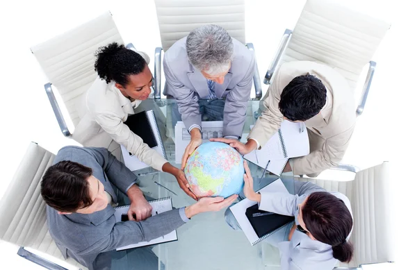 Serious international business team holding a terrestrial globe — Stock Photo, Image