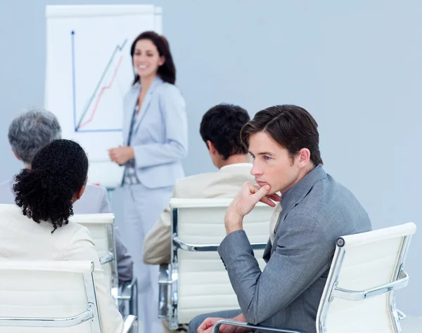 Bored young businessman at a presentation — Stock Photo, Image