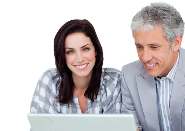 Two positive business co-workers using a laptop — Stock Photo, Image