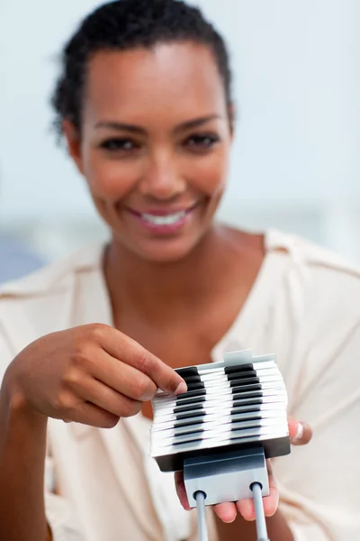 Confident businesswoman consulting a business card holder — Stock Photo, Image