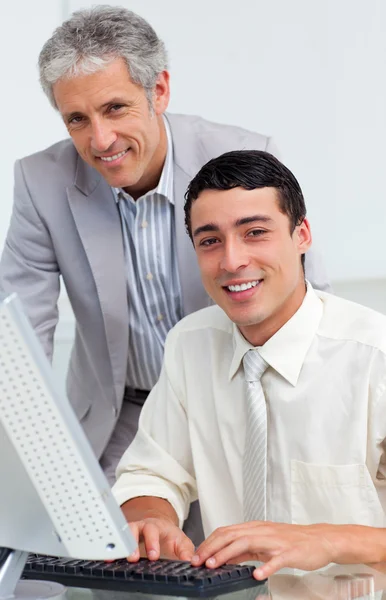 Cheerful colleagues working together at a computer — Stock Photo, Image