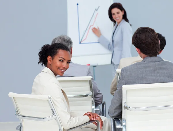 Charming businesswoman smiling at the camera at a conference — Stock Photo, Image