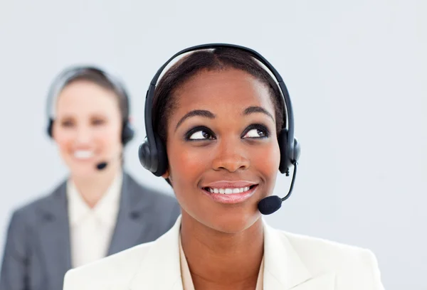 Charismatic businesswoman and her colleague with headset on — Stock Photo, Image