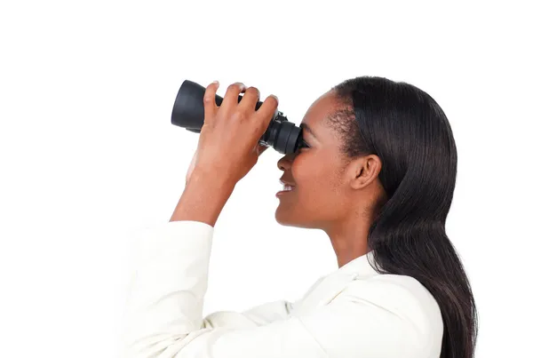 Portrait of a smiling businesswoman using binoculars — Stock Photo, Image