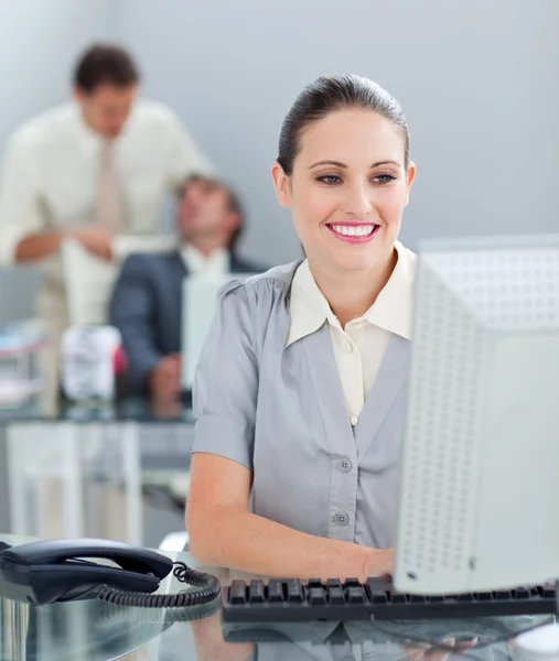 Radiant businesswoman working at a computer — Stock Photo, Image