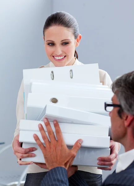 Elegant businesswoman carrying a stack of folders — Stock Photo, Image