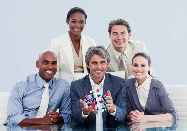 Ambitious business team showing a molecule — Stock Photo, Image