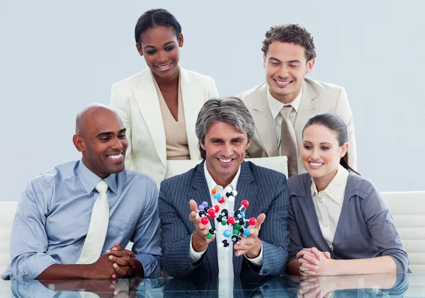 Animated business team showing a molecule — Stock Photo, Image